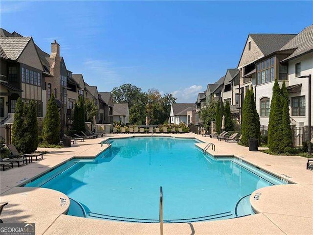 6635 Beacon Dr, Atlanta, GA 30328 - community pool featuring a residential view and a patio