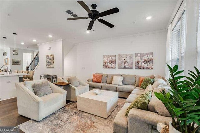6635 Beacon Dr, Atlanta, GA 30328 - living area with crown molding, recessed lighting, stairway, a ceiling fan, and wood finished floors