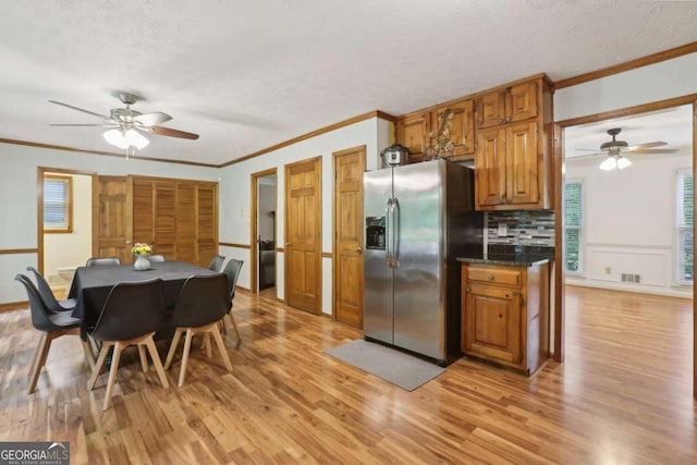 1369 Willowbrook Dr SW, Marietta, GA 30064 - kitchen featuring stainless steel refrigerator with ice dispenser, a ceiling fan, crown molding, light wood-style flooring, and a textured ceiling