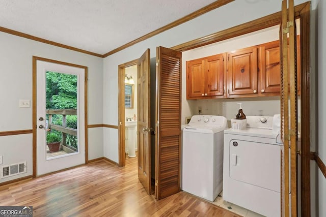 1369 Willowbrook Dr SW, Marietta, GA 30064 - washroom featuring cabinet space, separate washer and dryer, light wood finished floors, and ornamental molding