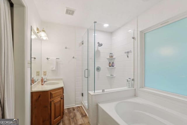 1369 Willowbrook Dr SW, Marietta, GA 30064 - full bath with a stall shower, vanity, a garden tub, and wood finished floors