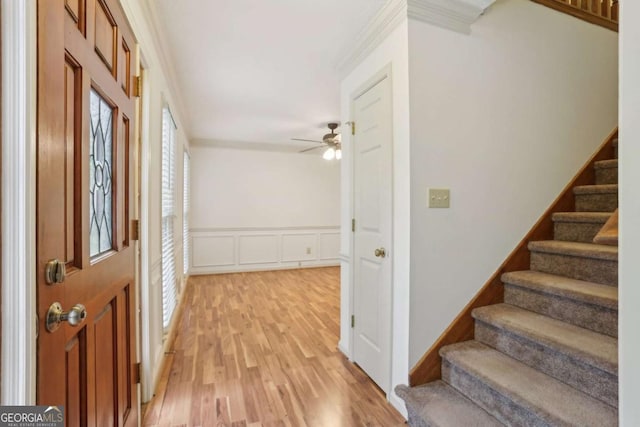 1369 Willowbrook Dr SW, Marietta, GA 30064 - foyer entrance with stairway, ornamental molding, a ceiling fan, light wood finished floors, and healthy amount of natural light