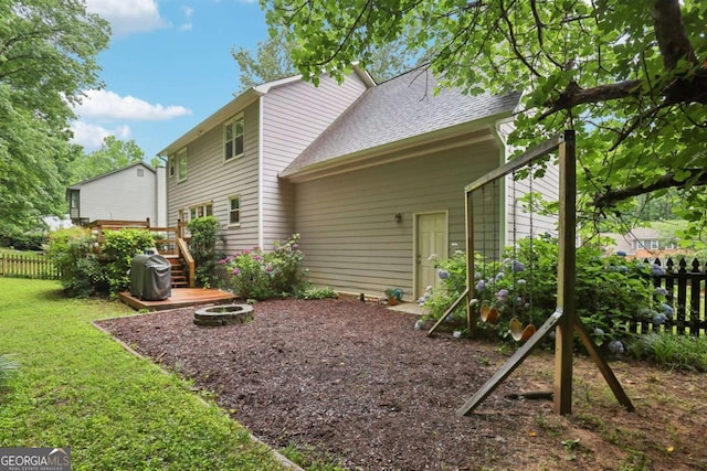 1369 Willowbrook Dr SW, Marietta, GA 30064 - rear view of house with an outdoor fire pit, a deck, and a shingled roof