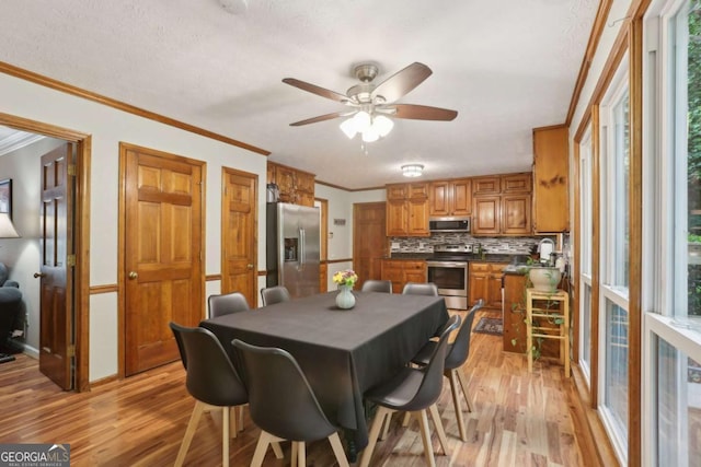 1369 Willowbrook Dr SW, Marietta, GA 30064 - dining space featuring light wood-style floors, ceiling fan, and ornamental molding
