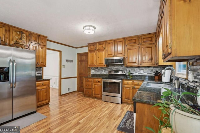 1369 Willowbrook Dr SW, Marietta, GA 30064 - kitchen featuring appliances with stainless steel finishes, tasteful backsplash, brown cabinets, light wood-type flooring, and crown molding