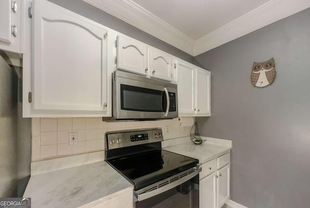 2700 Pine Tree Rd NE Unit 1013, Atlanta, GA 30324 - kitchen with appliances with stainless steel finishes, ornamental molding, light countertops, white cabinets, and tasteful backsplash