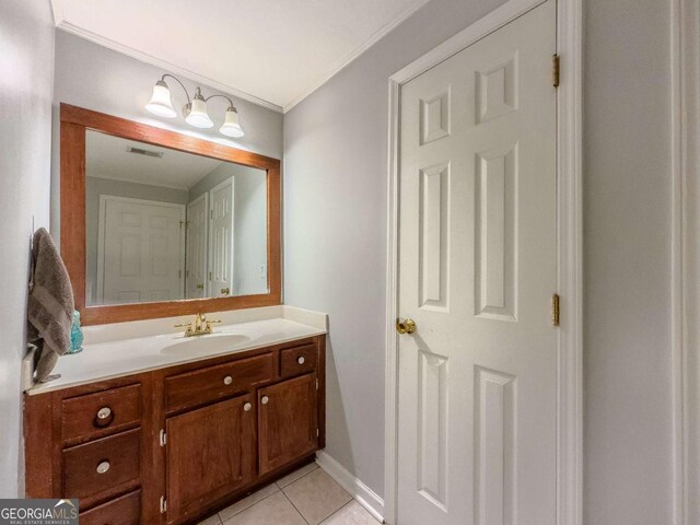2700 Pine Tree Rd NE Unit 1013, Atlanta, GA 30324 - bathroom with vanity, tile patterned floors, and ornamental molding