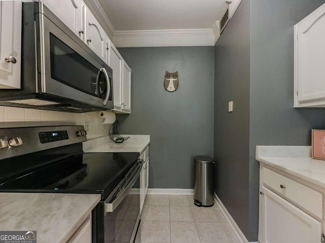 2700 Pine Tree Rd NE Unit 1013, Atlanta, GA 30324 - kitchen with stainless steel appliances, crown molding, white cabinets, tasteful backsplash, and light countertops