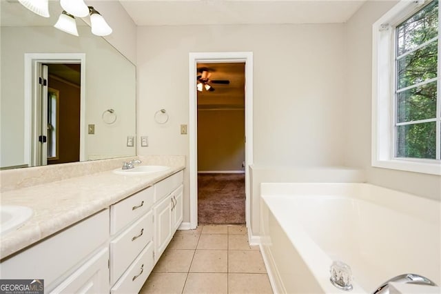 85 Chestnut Dr, Covington, GA 30016 - bathroom with tile patterned flooring, plenty of natural light, double vanity, and a bath