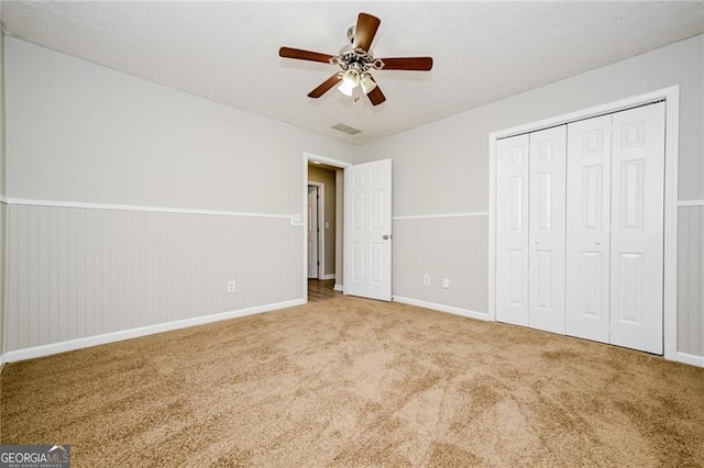 85 Chestnut Dr, Covington, GA 30016 - unfurnished bedroom with carpet flooring, baseboards, a closet, and a ceiling fan
