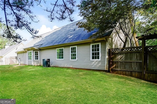 85 Chestnut Dr, Covington, GA 30016 - rear view of house with central AC and roof with shingles