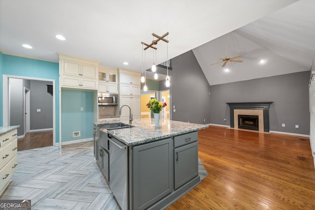 1440 Boundary Blvd, Suwanee, GA 30024 - kitchen featuring appliances with stainless steel finishes, a ceiling fan, a sink, light stone countertops, and recessed lighting