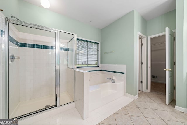 1440 Boundary Blvd, Suwanee, GA 30024 - bathroom featuring a garden tub, a shower stall, tile patterned floors, a walk in closet, and baseboards