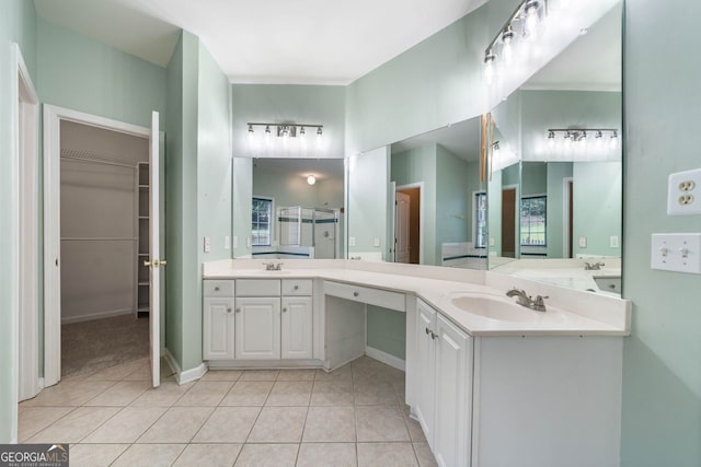 1440 Boundary Blvd, Suwanee, GA 30024 - full bath with double vanity, tile patterned floors, a spacious closet, a shower with door, and baseboards