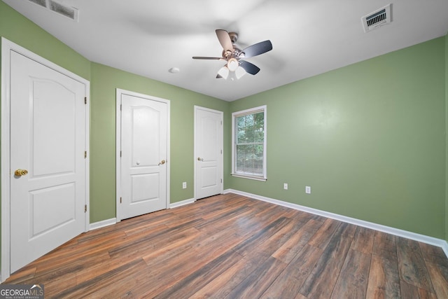 1440 Boundary Blvd, Suwanee, GA 30024 - unfurnished bedroom featuring baseboards, wood finished floors, and ceiling fan