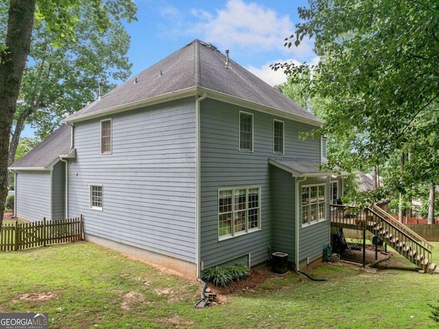 1440 Boundary Blvd, Suwanee, GA 30024 - view of home's exterior with stairway, a wooden deck, and roof with shingles