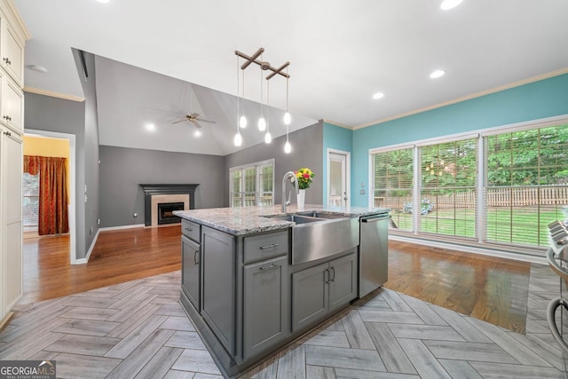 1440 Boundary Blvd, Suwanee, GA 30024 - kitchen featuring gray cabinets, dishwasher, a sink, a ceiling fan, and a fireplace