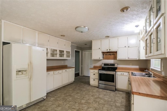 263 Austin Rd, Stockbridge, GA 30281 - kitchen featuring white fridge with ice dispenser, stainless steel range with electric stovetop, butcher block counters, white cabinets, and light floors