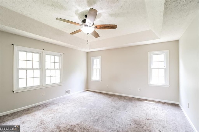 263 Austin Rd, Stockbridge, GA 30281 - carpeted empty room featuring a raised ceiling, a textured ceiling, and a ceiling fan