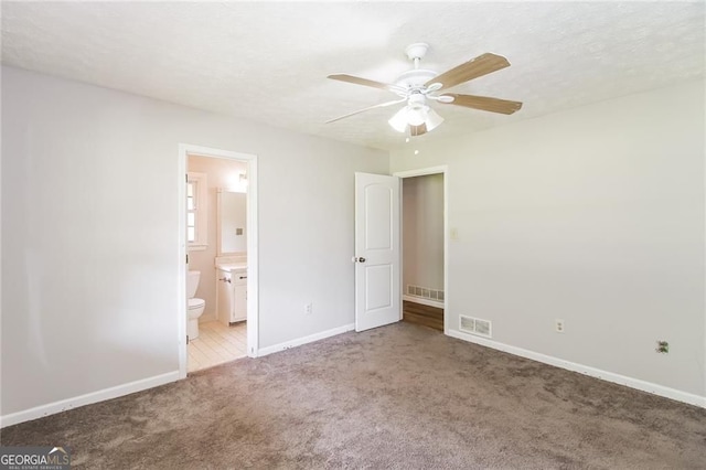 263 Austin Rd, Stockbridge, GA 30281 - unfurnished bedroom with carpet flooring, ensuite bathroom, and ceiling fan