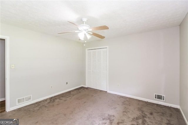 263 Austin Rd, Stockbridge, GA 30281 - unfurnished bedroom featuring carpet flooring, a closet, ceiling fan, and a textured ceiling