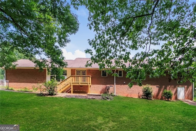 263 Austin Rd, Stockbridge, GA 30281 - back of property featuring brick siding, a lawn, a deck, and stairway