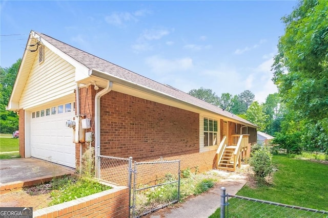 263 Austin Rd, Stockbridge, GA 30281 - view of side of property with brick siding, a gate, an attached garage, and driveway