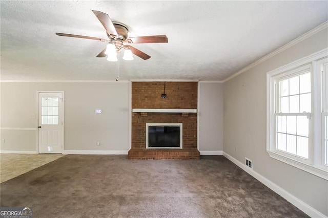 263 Austin Rd, Stockbridge, GA 30281 - unfurnished living room with carpet floors, ceiling fan, a fireplace, a textured ceiling, and ornamental molding