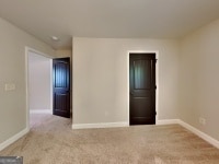 473 Cherry Creek Dr, Loganville, GA 30052 - unfurnished room with baseboards and carpet flooring