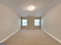 473 Cherry Creek Dr, Loganville, GA 30052 - carpeted spare room with baseboards
