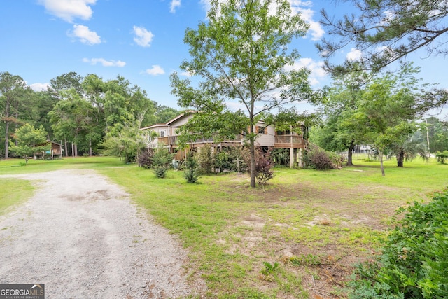 67 Lagoon Rd, Statesboro, GA 30461 - view of front facade featuring a front yard, a deck, stairs, and dirt driveway