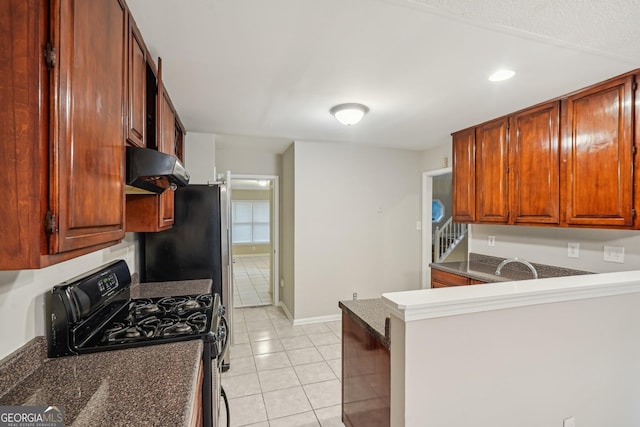 484 Culberson St SW, Atlanta, GA 30310 - kitchen featuring range with gas cooktop, exhaust hood, light tile patterned flooring, dark countertops, and a peninsula