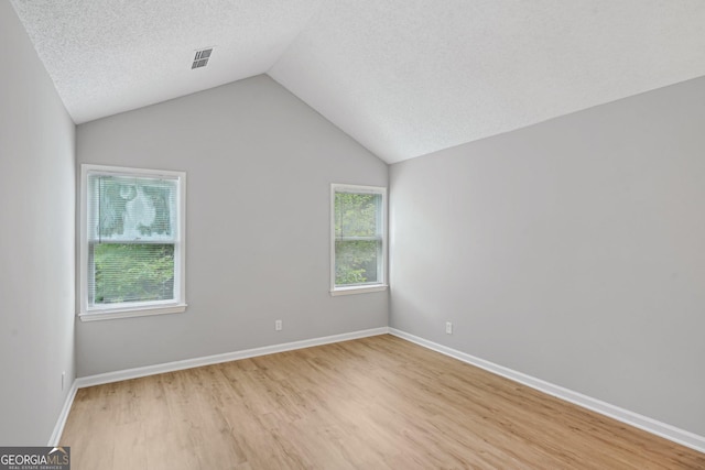 484 Culberson St SW, Atlanta, GA 30310 - unfurnished room featuring light wood-style floors, vaulted ceiling, and a textured ceiling