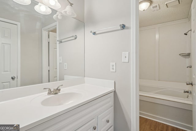 484 Culberson St SW, Atlanta, GA 30310 - bathroom featuring vanity, wood finished floors,  shower combination, and a textured ceiling