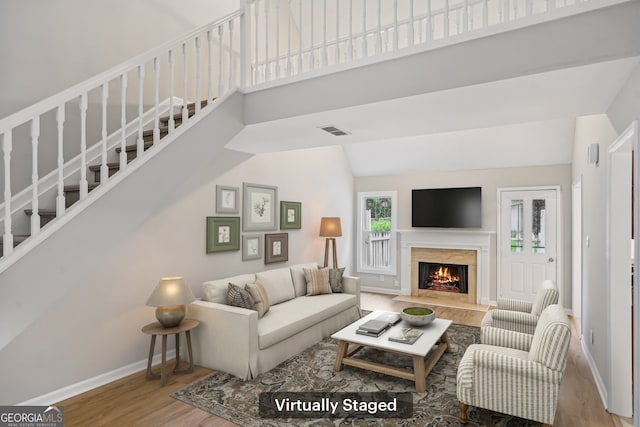 484 Culberson St SW, Atlanta, GA 30310 - living area featuring wood finished floors, a premium fireplace, stairs, and high vaulted ceiling