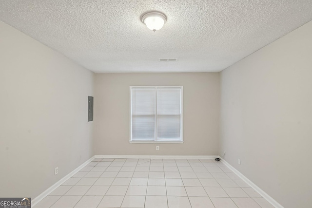 484 Culberson St SW, Atlanta, GA 30310 - empty room featuring a textured ceiling, light tile patterned floors, and electric panel