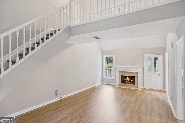 484 Culberson St SW, Atlanta, GA 30310 - unfurnished living room with wood finished floors, stairway, a premium fireplace, and high vaulted ceiling