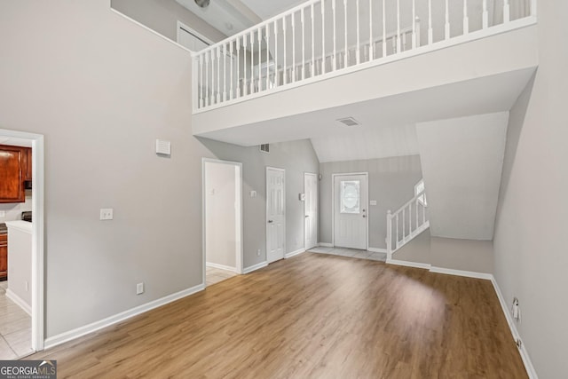 484 Culberson St SW, Atlanta, GA 30310 - unfurnished living room featuring a high ceiling, light wood finished floors, and stairs