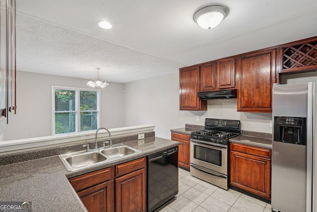 484 Culberson St SW, Atlanta, GA 30310 - kitchen featuring appliances with stainless steel finishes, dark countertops, under cabinet range hood, light tile patterned floors, and pendant lighting