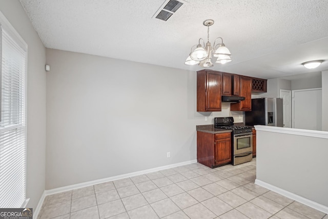 484 Culberson St SW, Atlanta, GA 30310 - kitchen featuring appliances with stainless steel finishes, a chandelier, a textured ceiling, pendant lighting, and light tile patterned floors