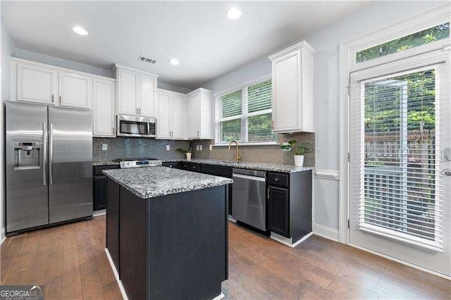 2069 Brightleaf Way Unit 123, Marietta, GA 30060 - kitchen with appliances with stainless steel finishes, white cabinetry, light stone countertops, dark wood-style flooring, and recessed lighting