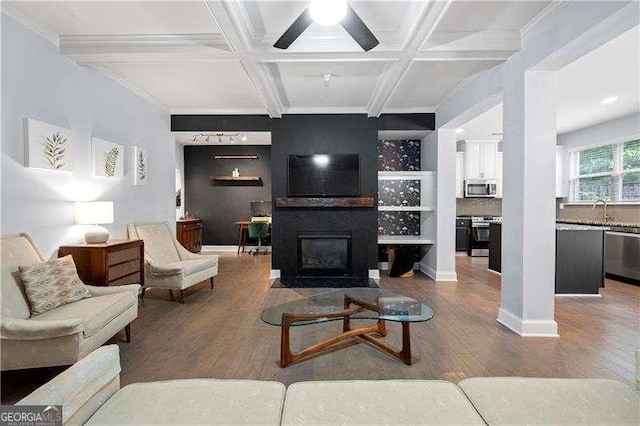 2069 Brightleaf Way Unit 123, Marietta, GA 30060 - living area featuring wood finished floors, coffered ceiling, a fireplace with flush hearth, beamed ceiling, and ceiling fan