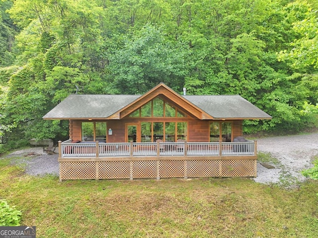 481 Georgianna Ln, Bryson City, NC 28713 - rear view of house featuring a forest view, a lawn, and a shingled roof