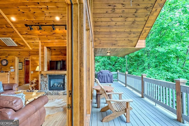 481 Georgianna Ln, Bryson City, NC 28713 - living room with track lighting, wood ceiling, vaulted ceiling, wood walls, and wood-type flooring