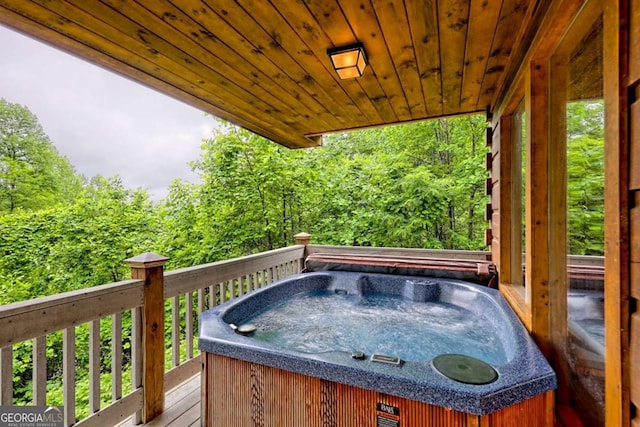 481 Georgianna Ln, Bryson City, NC 28713 - deck featuring a hot tub and a wooded view