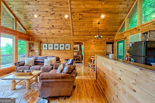 481 Georgianna Ln, Bryson City, NC 28713 - living room with wooden walls, wooden ceiling, hardwood / wood-style flooring, a chandelier, and high vaulted ceiling