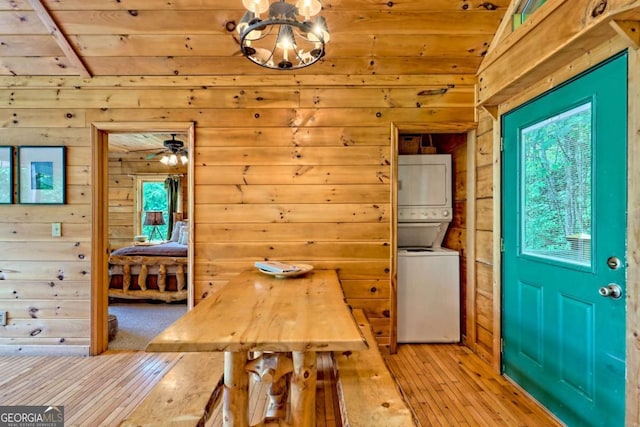 481 Georgianna Ln, Bryson City, NC 28713 - dining space with stacked washer / drying machine, light wood-style floors, wood walls, wood ceiling, and healthy amount of natural light
