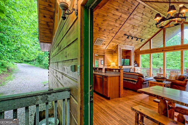 481 Georgianna Ln, Bryson City, NC 28713 - living area with high vaulted ceiling, wood ceiling, light wood-type flooring, a chandelier, and wood walls