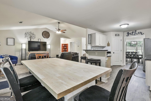 279 Brenna Ct, Luthersville, GA 30251 - dining room featuring a ceiling fan, wood finished floors, and lofted ceiling