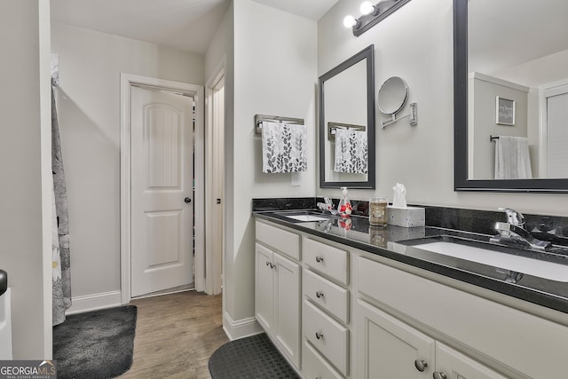 279 Brenna Ct, Luthersville, GA 30251 - bathroom featuring double vanity, wood finished floors, and baseboards